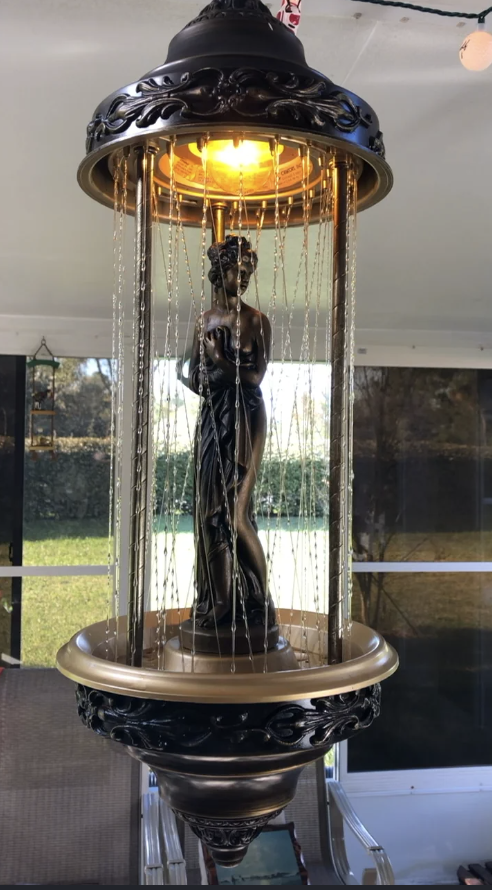 A vintage oil rain lamp lit in a dark room