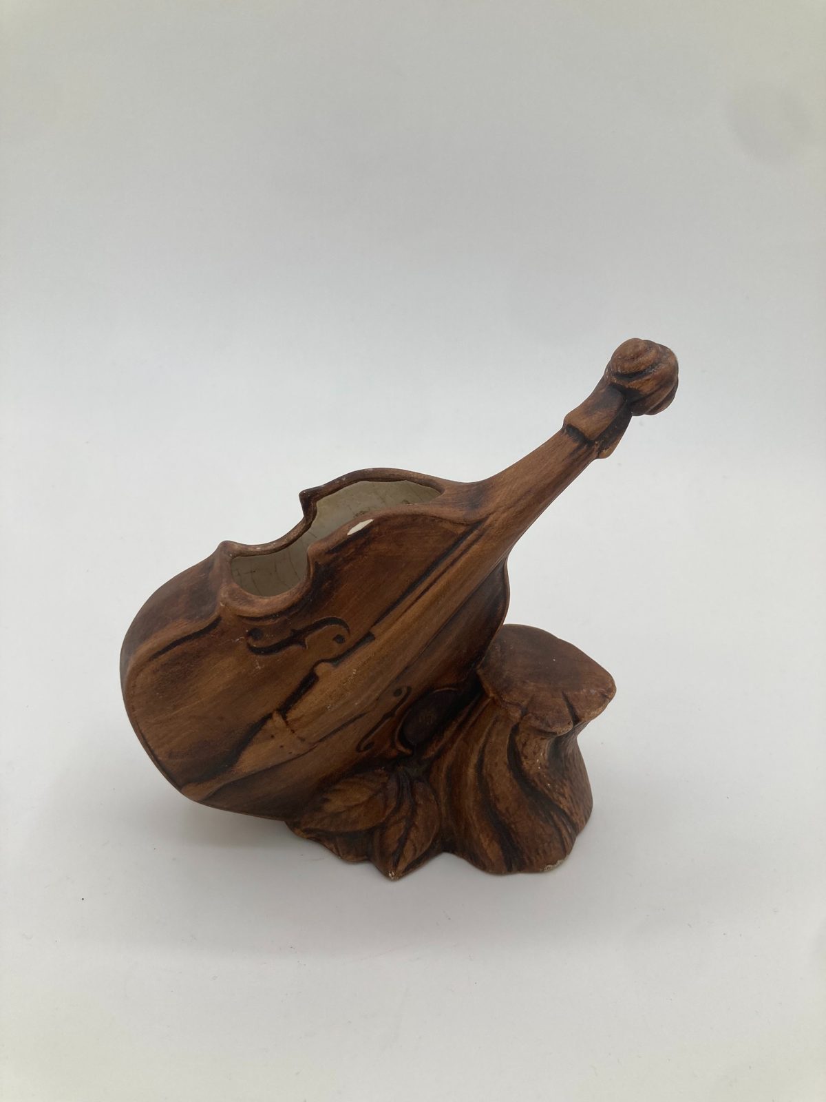 Product shot: ceramic planter shaped like a cello